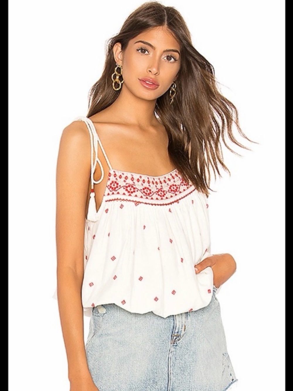 Free People cropped white tank top with red embroidered details.